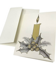 The Strawberry Shop ivory Christmas card featuring a gold candle and holly illustration with crystal embellishments.