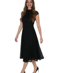 Model wearing a black Frank Lyman midi dress with lace detailing and cap sleeves from The Strawberry Shop