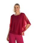 The Strawberry Shop Frank Lyman red chiffon layered top with split sleeves worn by a model in a garden setting