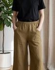 Model wearing The Strawberry Shop Kleen hickory capri pants with an elastic waist and pockets, styled with a black tee