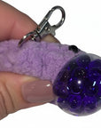 The Strawberry Shop purple crochet stress ball blob keychain with a squishy bubble texture and silver lobster clasp.