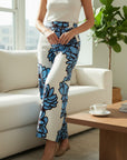 The Strawberry Shop It's Only Natural in Bloom linen pants in cream with a bold blue floral print. Wide leg, machine washable.