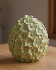 The Strawberry Shop decorative egg covered in pale yellow flowers with glitter accents.
