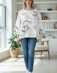 The Strawberry Shop white 3/4 sleeve top with a black and grey bamboo print and round neck.