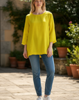 The Strawberry Shop yellow linen blend A-line top with 3/4 sleeves and raw edge hem detail.