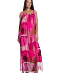 The Strawberry Shop Marla maxi dress in pink geometric silk with spaghetti straps and side slits on a model