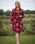 The Strawberry Shop La Mer Luxe Lily dress, black with pink and red floral print, 3/4 sleeves, collared, gold button front, tie waist. 100% Rayon.