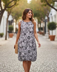 The Strawberry Shop black and white floral print sleeveless rayon-blend dress with elastic hem detail.