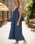 The Strawberry Shop Citron Bleu blue sleeveless maxi dress with a high V-neck and flared hem.