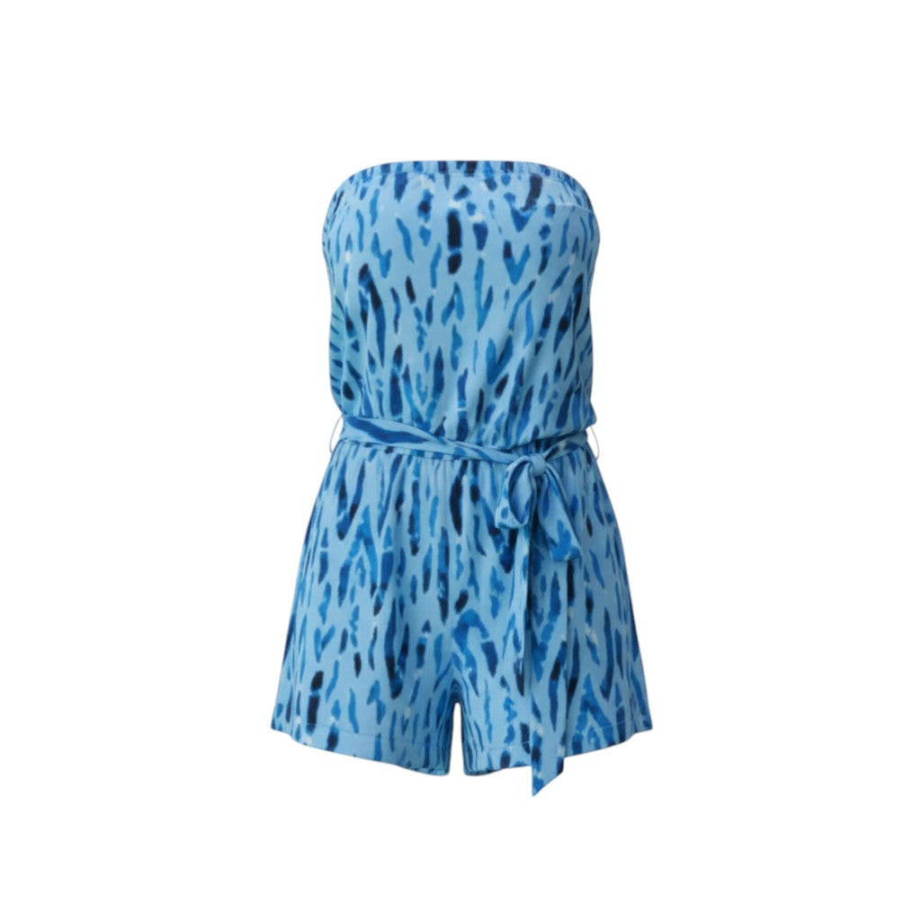 The Strawberry Shop strapless knit Raina romper in navy and blue tie-dye print with a belted waist and side slits. Made of polyester and spandex.