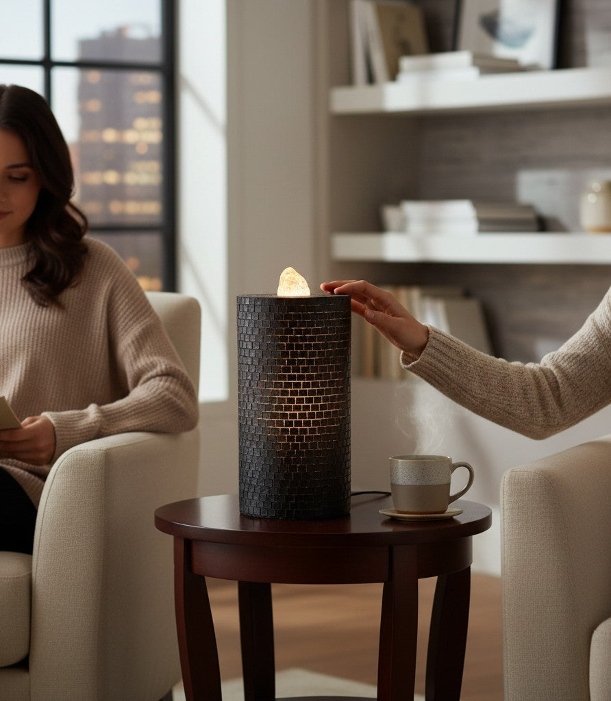 The Strawberry Shop black brick water candle with warm LED light on a side table in a cozy living room setting.