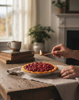 The Strawberry Shop cherry pie candle with a golden crust and a glossy cherry filling.