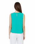 The Strawberry Shop Compli K sleeveless crew neck top in bright turquoise polyester with button keyhole closure.