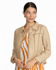 Model wearing The Strawberry Shop FOIL sand linen jacket with fringe trim over a patterned dress