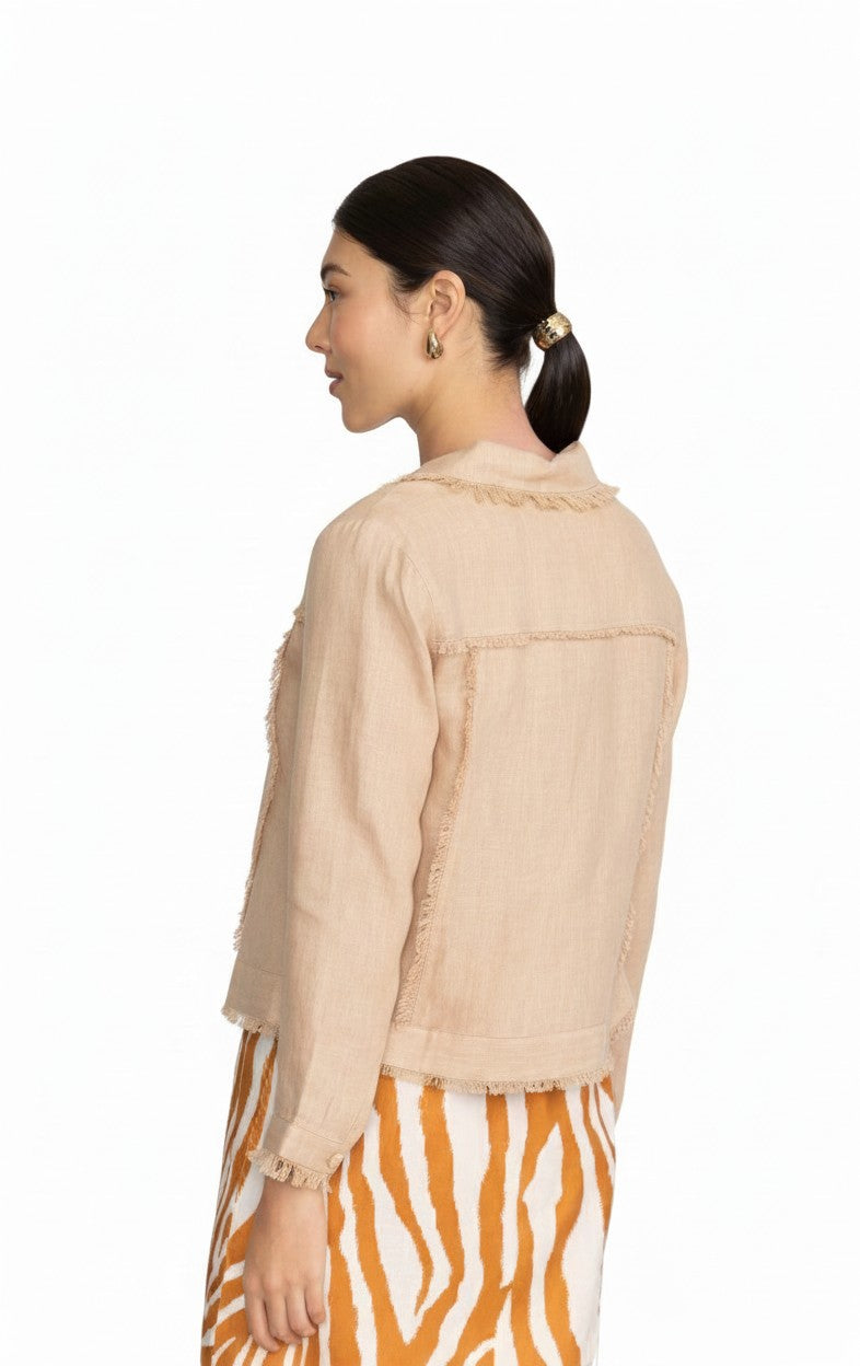 Model wearing a sand-colored FOIL linen fringe jacket with textured trim from The Strawberry Shop
