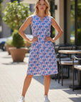 The Strawberry Shop sleeveless cotton slub dress with notch neck and fan print in blue, pink, and purple. Features 2 side pockets.