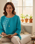 The Strawberry Shop Kleen Ocean Swing Top in turquoise blue with white tie-dye pattern, 3/4 sleeves, round neck, and high-low hem. 100% linen.