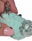 The Strawberry Shop mint green crochet blob keychain with a squishy gel bead stress ball center and silver clasp.