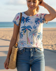 The Strawberry Shop white short sleeve top with blue palm trees and pink surfboards. Polyester-viscose blend.