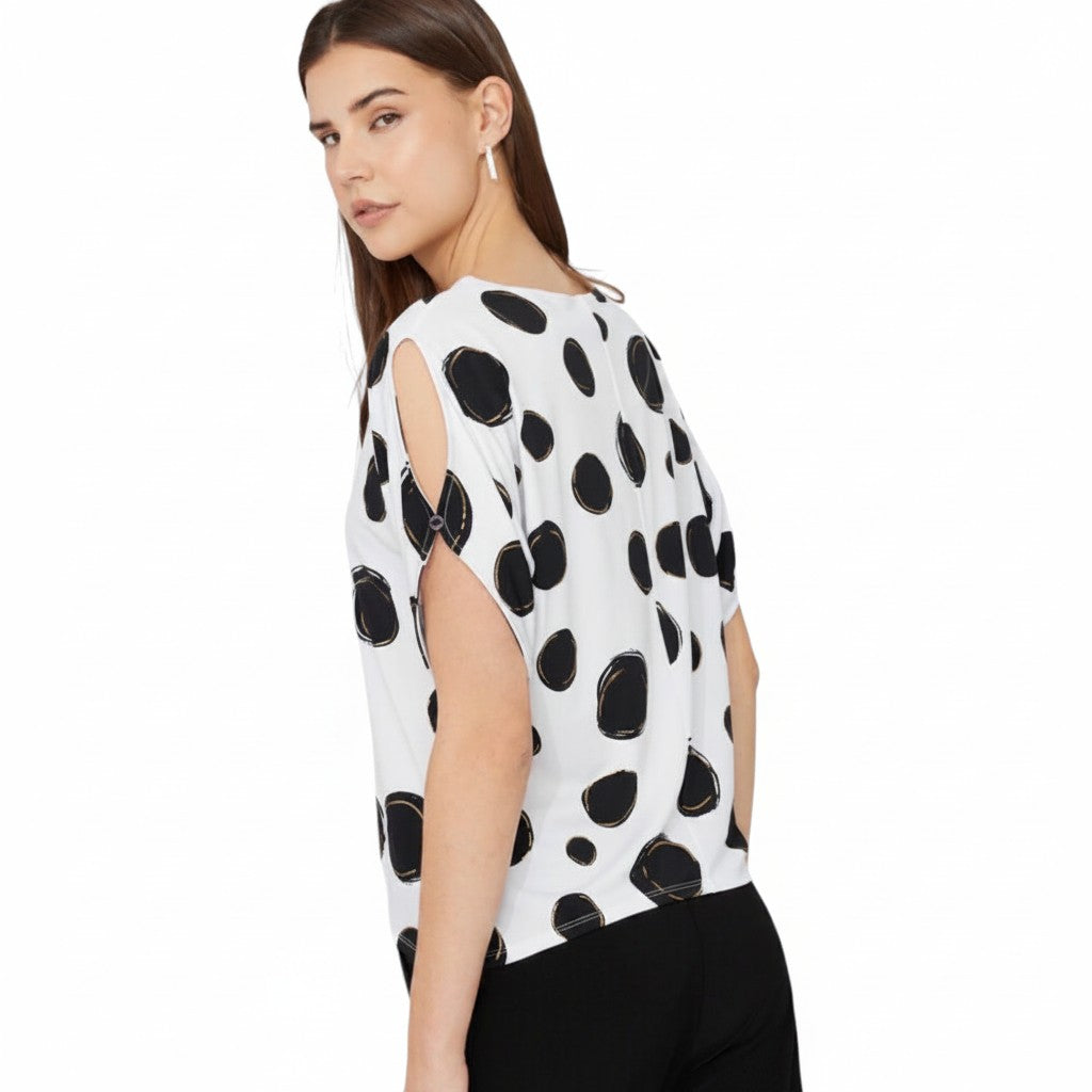 The Strawberry Shop white short-sleeve top with black polka dots and cut-out details on sleeves. Made of polyester and spandex.