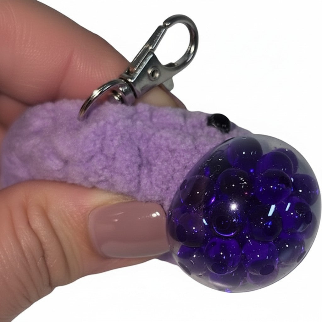 The Strawberry Shop purple crochet stress ball blob keychain with a squishy bubble texture and silver lobster clasp.