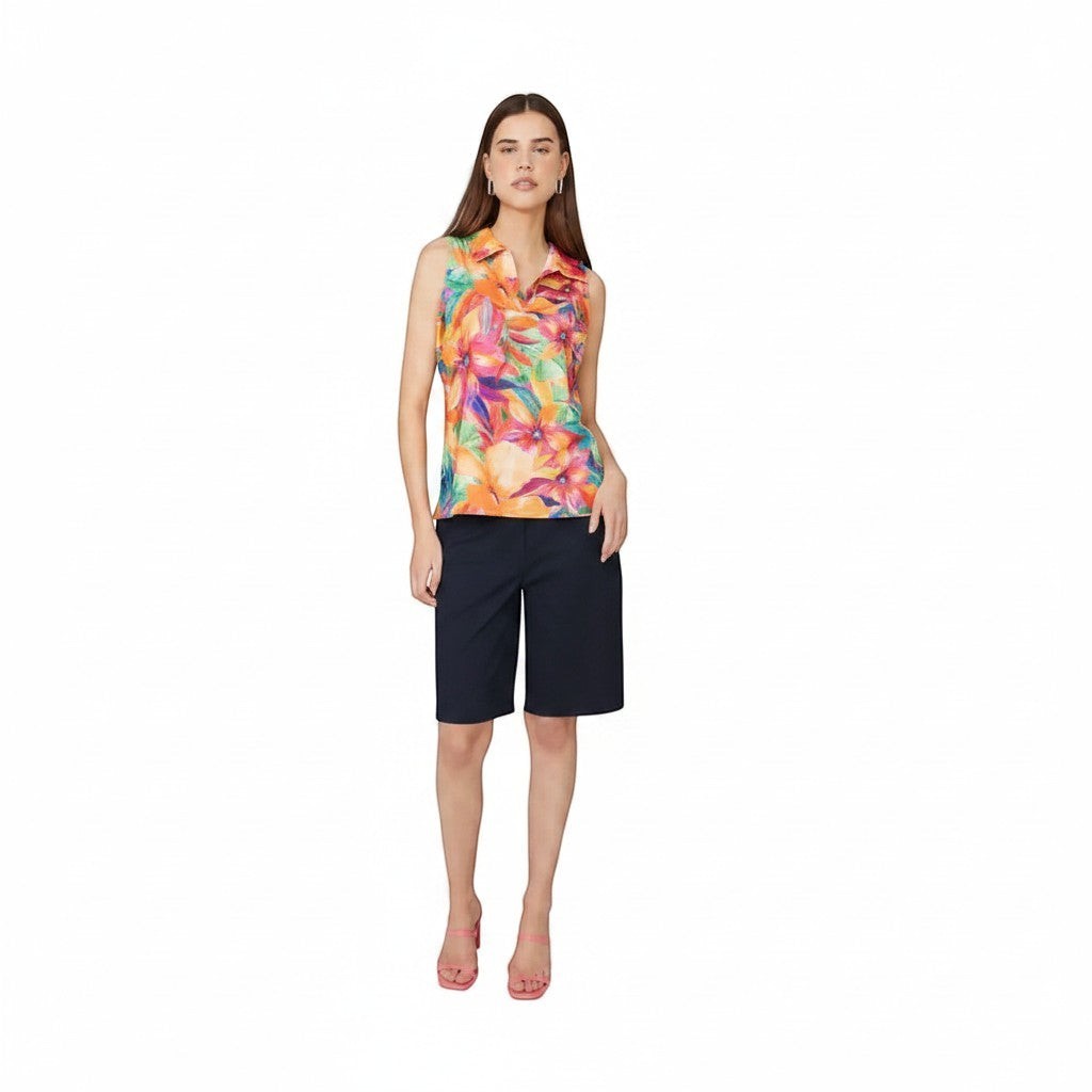 The Strawberry Shop white knee-length shorts with a flat front and tailored fit, paired with a colorful floral sleeveless top.