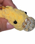 The Strawberry Shop yellow crochet smiley face keychain with a clear bubble charm and gold lobster clasp.