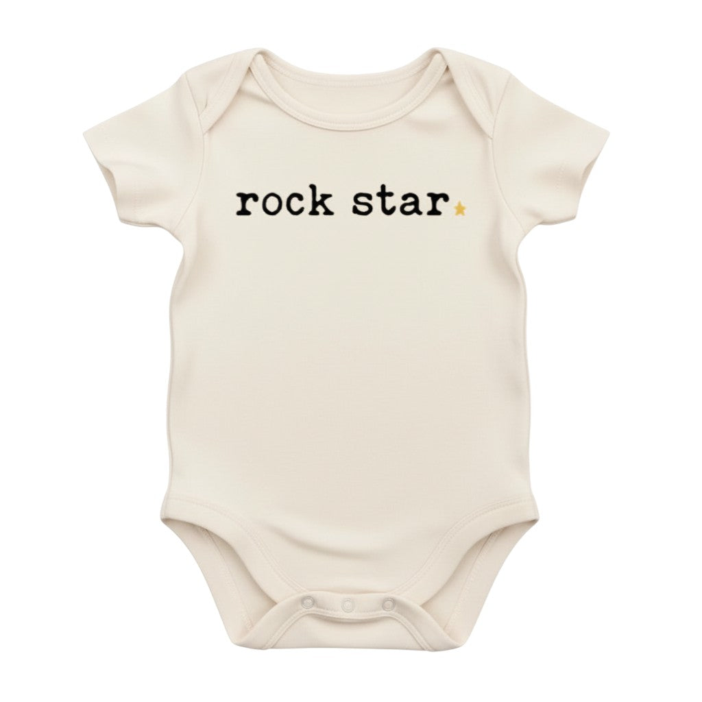 The Strawberry Shop cream organic cotton short-sleeve baby bodysuit with "rock star" text and a small yellow star.