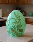 The Strawberry Shop mint green egg decor with embossed gold floral designs, perfect for spring or Easter.