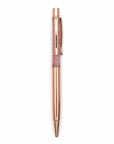 The Strawberry Shop Snifty Glitter Pen with rose gold barrel and pink glitter-filled barrel.