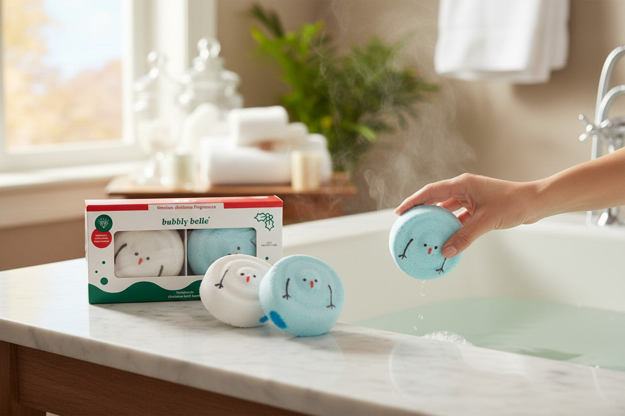 The Strawberry Shop Bubbly Belle set of 2 handmade snowman bath bombs, one white and one blue, with Christmas fragrances.