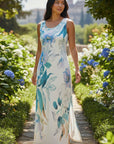 The Strawberry Shop sleeveless white dress with blue floral print and scoop neckline.