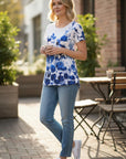 The Strawberry Shop white short sleeve top with blue floral print and round neck.