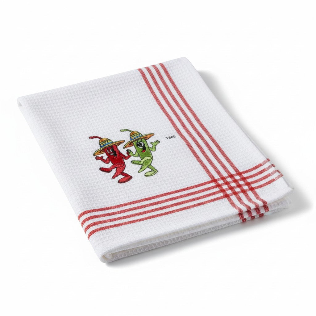 The Strawberry Shop Sinobrite Linens T880 white kitchen towel with red stripes and embroidered dancing chili peppers wearing sombreros.